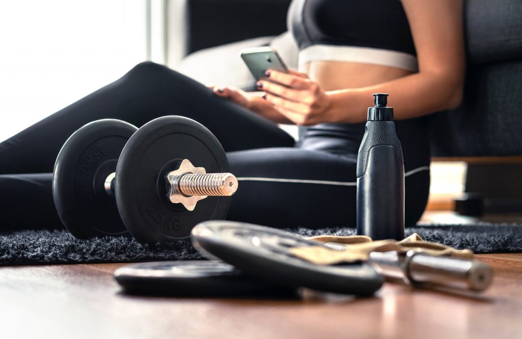 El entrenamiento de fuerza es fundamental Mujer joven haciendo pesas en su casa